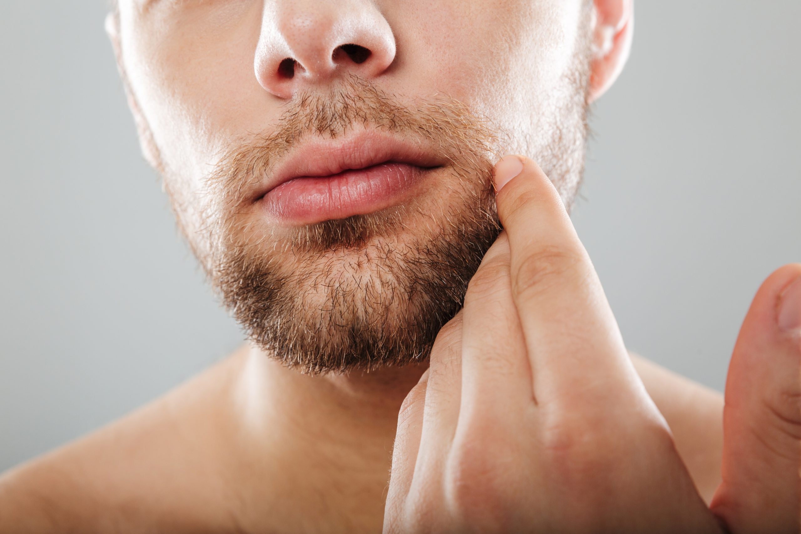 close up portrait bearded half men s face with hand scaled